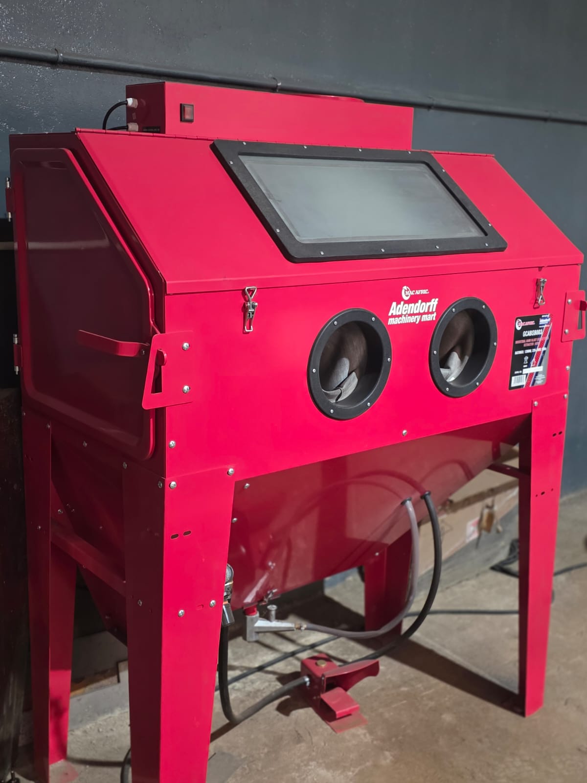 Industrial sand-blasting cabinet used for surface preparation