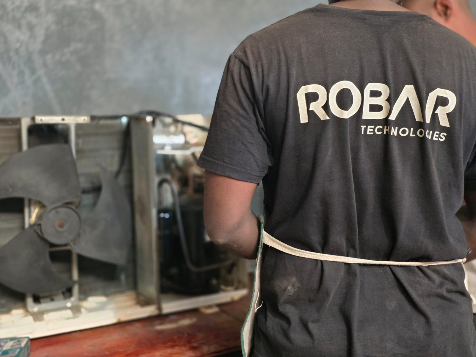 Robar Technologies technician servicing a refrigeration compressor unit