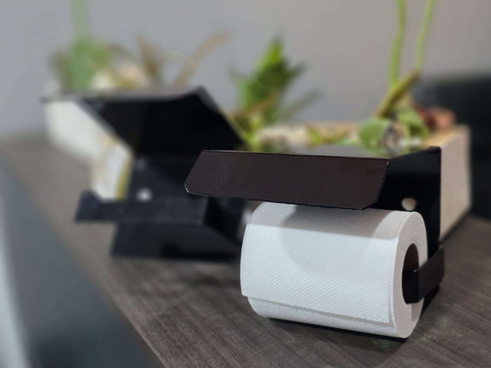 Custom black steel toilet-roll holder with a shelf