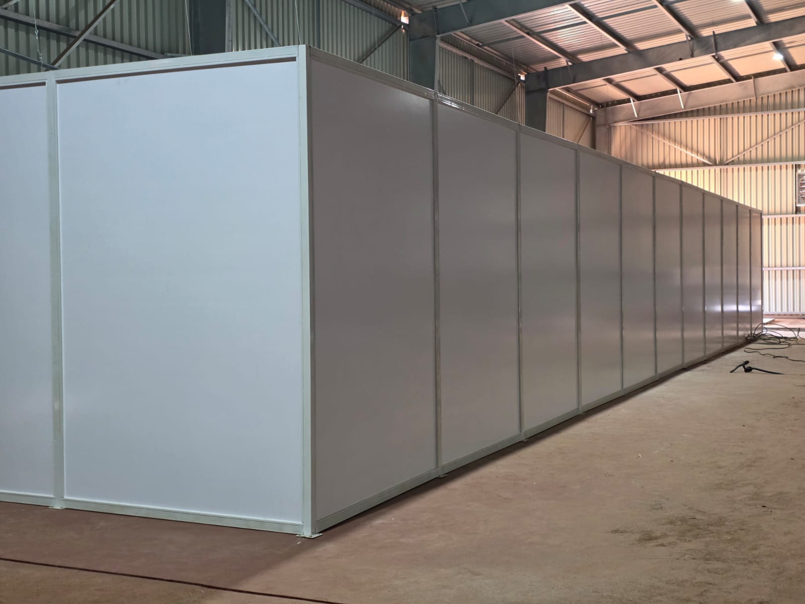 Insulated sandwich-panel room under construction in a warehouse
