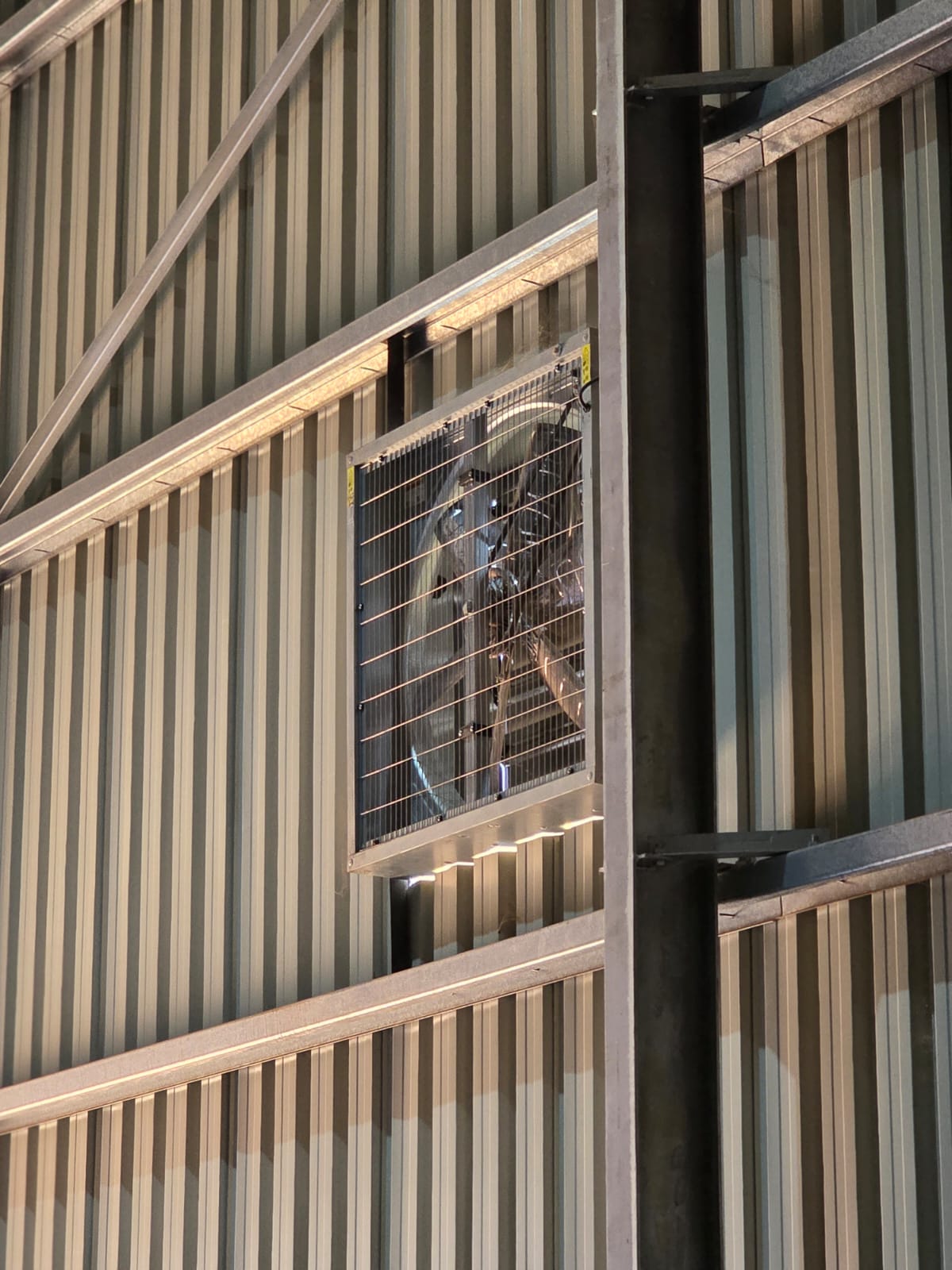 Industrial wall extraction fan installed in a steel-clad building