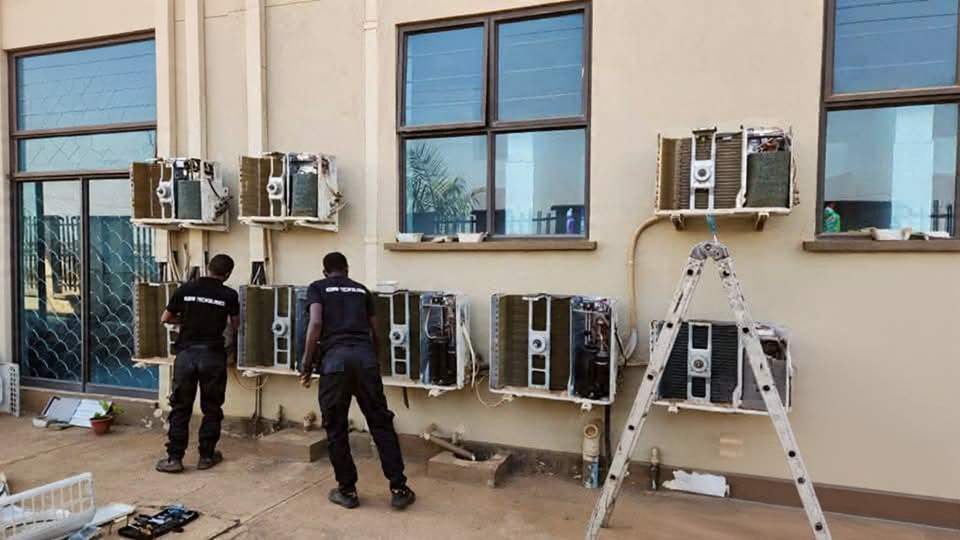 Robar Technologies team servicing a row of split air-conditioning units