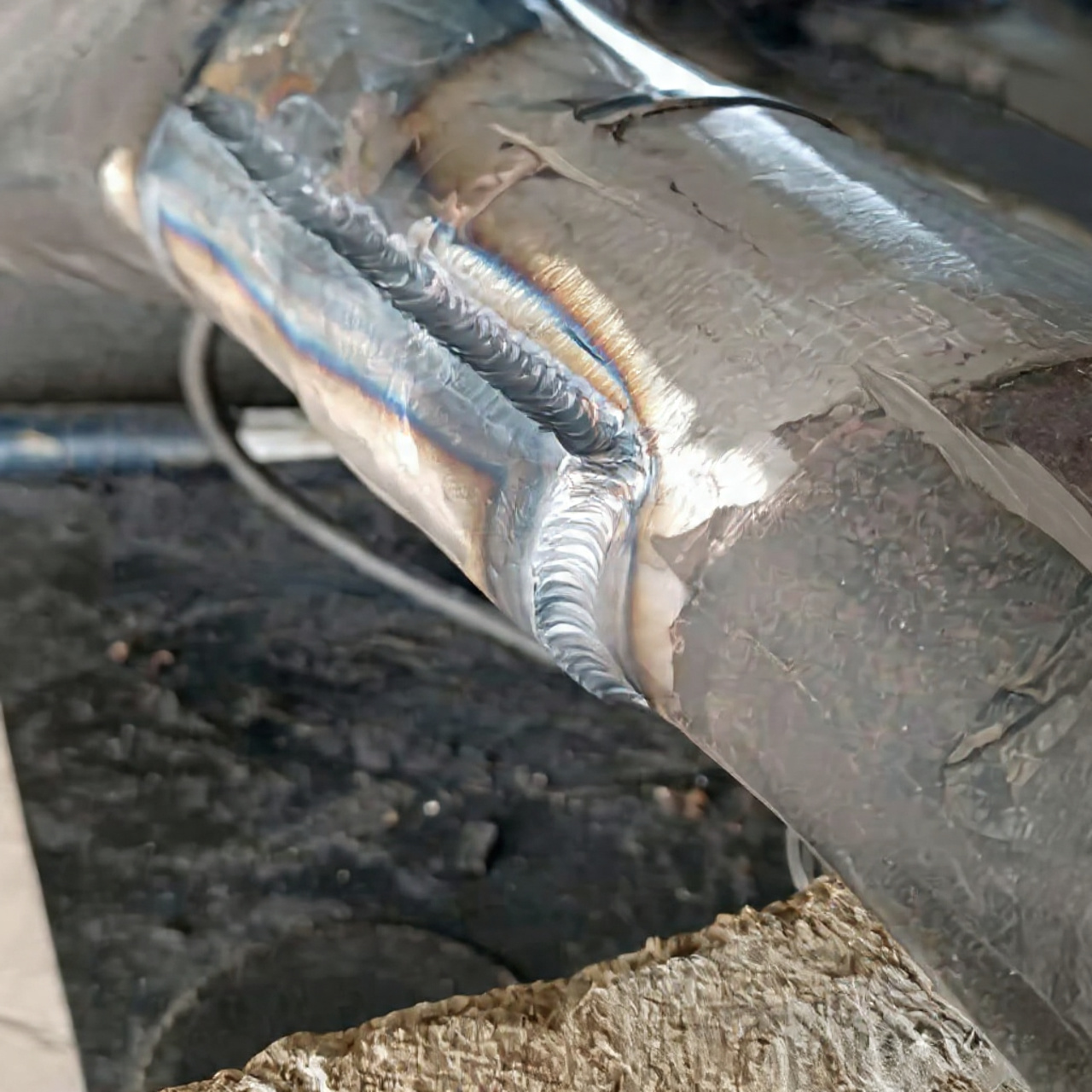 Close-up of a clean TIG weld bead on a stainless steel pipe